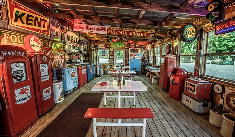 An old fashioned gas station with lots of old signs located on Route 66 in Missouri.