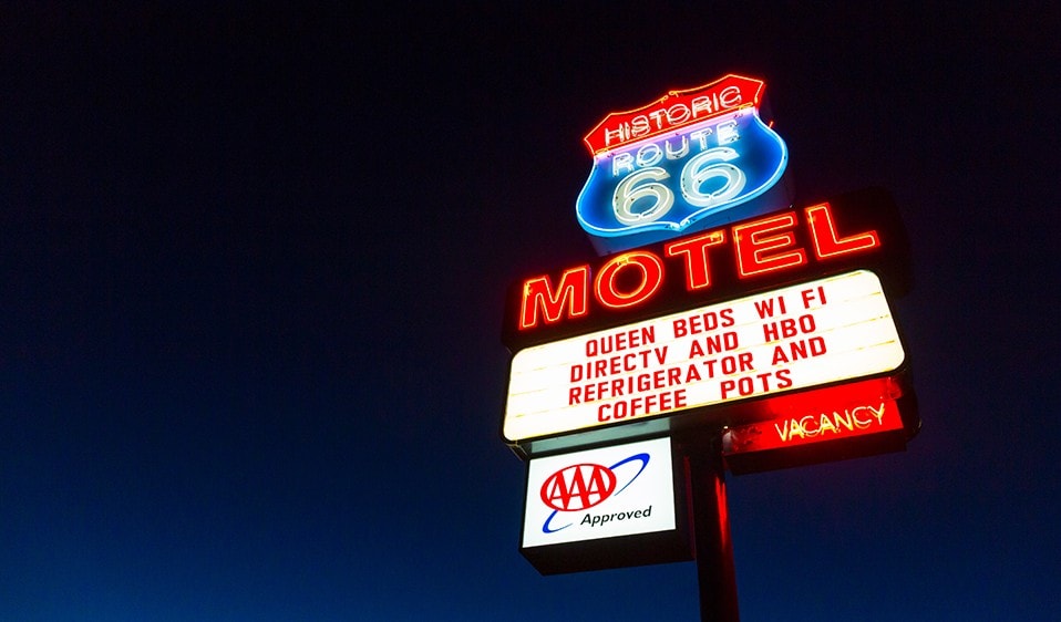 A nighttime motel sign.