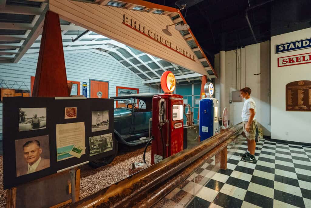 Child observes Phil Check Service exhibit at Route 66 Museum