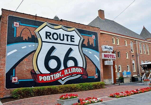 A mural of Route 66 on the side of a brick building, capturing the Illinois Odyssey.